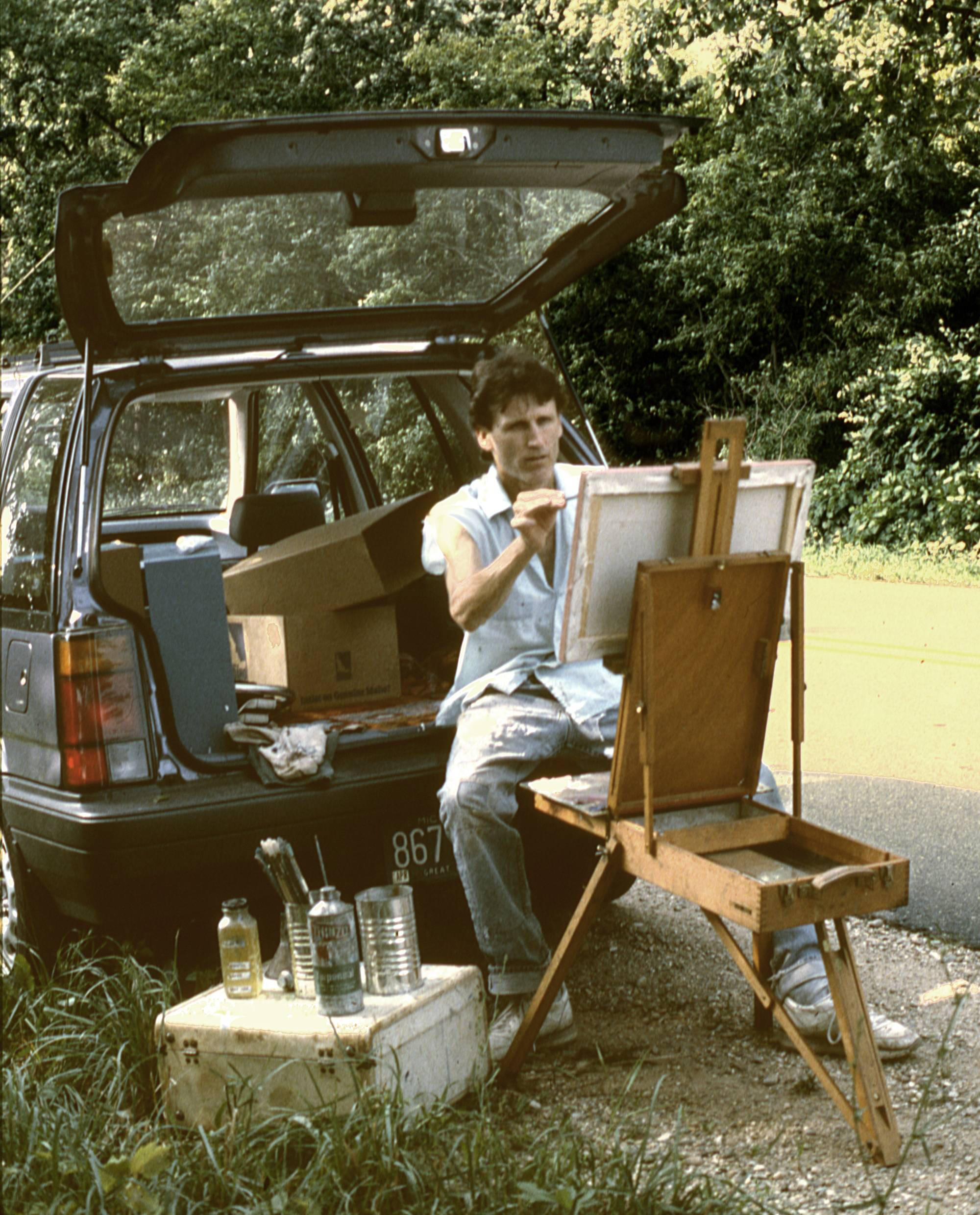 Photograph of Stephen Duren plein-air painting out of the back of his car.